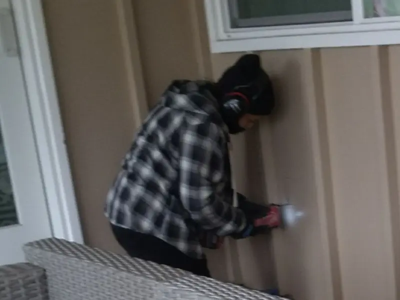 Professional electrician installing an exterior outlet in Flower Hill